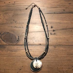 Teal beaded necklace with teal and silver pendant